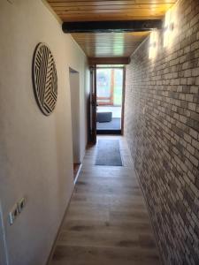 a hallway of a house with a brick wall at Ferienhaus St Martin in Schalkenmehren