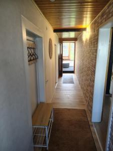 a hallway with a table and a brick wall at Ferienhaus St Martin in Schalkenmehren