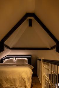 a bedroom with a bed in a room with a ceiling at Maison Hans in Loenen aan de Vecht