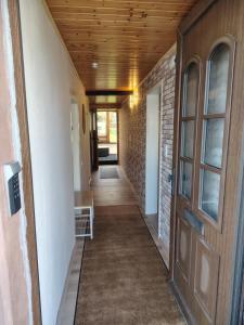 a hallway of a house with a wooden ceiling at Ferienhaus St Martin in Schalkenmehren