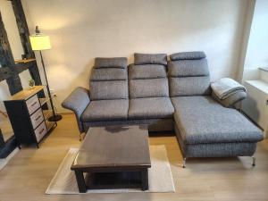 a living room with a couch and a coffee table at Ferienhaus St Martin in Schalkenmehren +62 photos