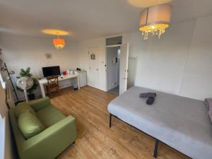a living room with a bed and a couch at Overton in London