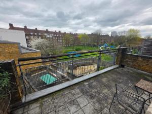 a balcony with a metal fence and a playground at Overton in London