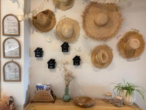 a wall with straw hats on a wall at Montroig 5 hotel boutique in Sitges +77 photos