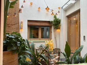 a house with a bunch of plants and lights at Montroig 5 hotel boutique in Sitges