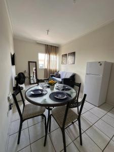 a living room with a table and chairs and a refrigerator at next event patio for 06 people in Petrolina +23 photos