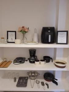a kitchen shelf with various items on it at El refugio in Búzios
