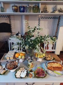 a table with many plates of food on it at Maison Lasmarenx chambres d'hôtes in Jurançon