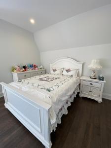a white bedroom with a white bed and two night stands at B-Willowdale Cummer Residence -Queen bedroom near Yonge-Finch in Toronto