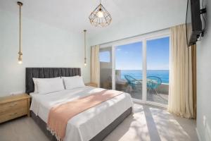 a bedroom with a bed and a large window at Villa Leo in Barbati