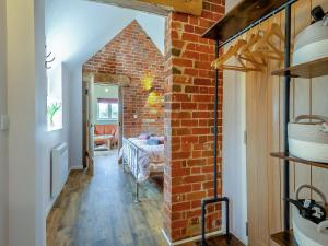 a hallway with a brick wall and a room at Alberts Dairy in Diss +13 photos