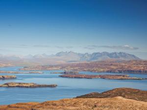 a large body of water with mountains in the background at Taigh Mullach Dearg in Portree