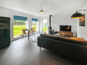 a living room with a couch and a table at Taigh Mullach Dearg in Portree