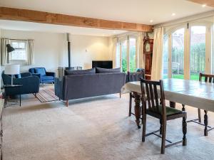 a living room with a couch and a table at The Cart House in Helmsley