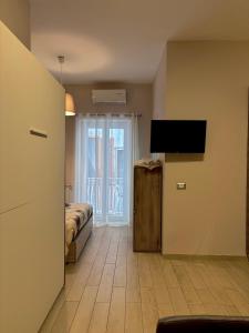 a room with a bed and a television on a wall at Il Palazzetto in Gaeta +42 photos