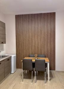 a dining room with a table and chairs in a kitchen at Il Palazzetto in Gaeta