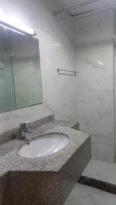 a bathroom with a sink and a mirror at Oasis TOWER 1105 in Ajman 