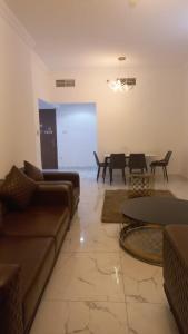 a living room with a couch and a table at Oasis TOWER 1105 in Ajman 