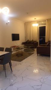 a living room with a couch and a tv at Oasis TOWER 1105 in Ajman 