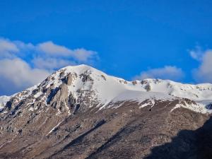 a mountain with snow on top of it at Da Papone in Massa dʼAlbe