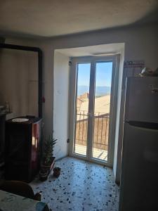 a room with a door leading to a balcony with a view at Da Papone in Massa dʼAlbe