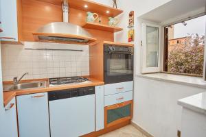 a kitchen with a sink and a stove top oven at A due passi dal Teatro Massimo in Palermo