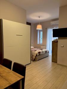 a bedroom with a bed and a table and a cabinet at Il Palazzetto in Gaeta