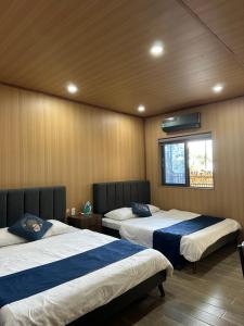 a bedroom with two beds and a window in it at The mountain Seaview in Vung Tau