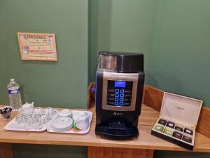 a coffee maker sitting on top of a table at Phenix Hôtel Limoges in Limoges
