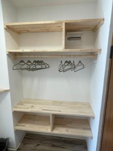 a walk in closet with wooden shelves at Studio Pod Kaninom in Bovec