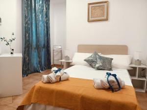 a bedroom with a bed with towels on it at DomusVenere in Santa Croce Camerina