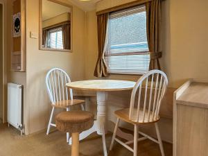 a small kitchen with a table and two chairs at Uk51366 - The Harley Davidson in Brechin