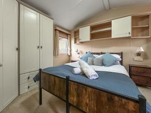 a bedroom with a bed with two pillows on it at Uk51366 - The Harley Davidson in Brechin