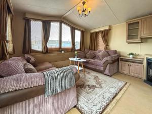a living room with a bed and a couch at Uk51366 - The Harley Davidson in Brechin +4 photos