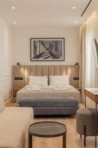 a bedroom with two beds and a bridge picture on the wall at Mouragia by Kantoni in Corfu
