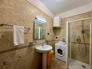 a bathroom with a sink and a washing machine at Lighthouse Rafailovići, Budva in Rafailovici +11 photos