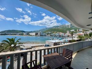 a balcony with a bench and a view of a beach at Lighthouse Rafailovići, Budva in Rafailovici