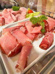 a plate of ham and other meats on a table at Sport hotel POMI in Harrachov