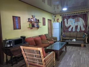 a living room with a couch and a table at Hostel Archimedes in Paramaribo