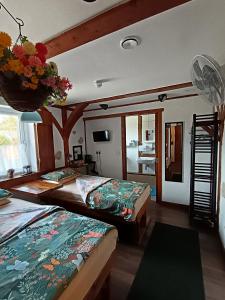 a bedroom with two beds and a room with a kitchen at Birchwood Guest Lodge in Balmaha