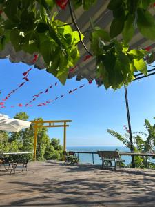 a patio with benches and a view of the ocean at The mountain Seaview in Vung Tau
