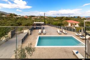 a swimming pool on top of a house at Athenia Apartments in Vasilikos