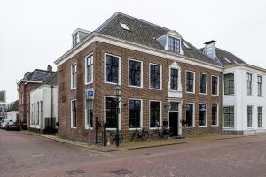 a large brick building on a city street at De Buitenplaats in Loenen aan de Vecht