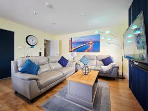 a living room with a couch and a table at Bournemouth Luxury Apartment in Bournemouth