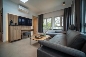 a living room with a couch and a table at MSLiving Hotels in Hannover