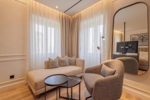 a living room with a couch and a mirror at Mouragia by Kantoni in Corfu