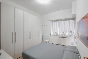 a white bedroom with a bed and a window at Casa Vacanze MaRoSa - Rapallo, Bixio in Rapallo