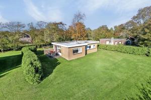 a large yard with a tiny house on it at Dunopark Bungalow in Oostkapelle