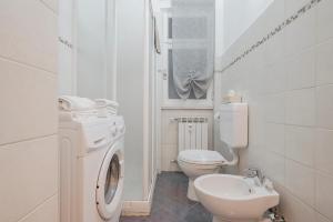 a white bathroom with a toilet and a sink at Casa Vacanze MaRoSa - Rapallo, Bixio in Rapallo +14 photos