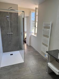 a bathroom with a shower with a glass door at Logis Hôtel Restaurant Le Pradinas in Anduze +51 photos